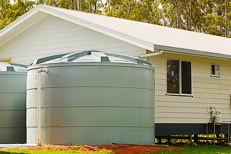 Two water storage systems outside of a house